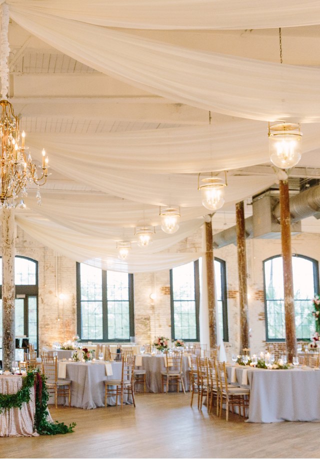 Ballroom wedding reception with lighting and décor
